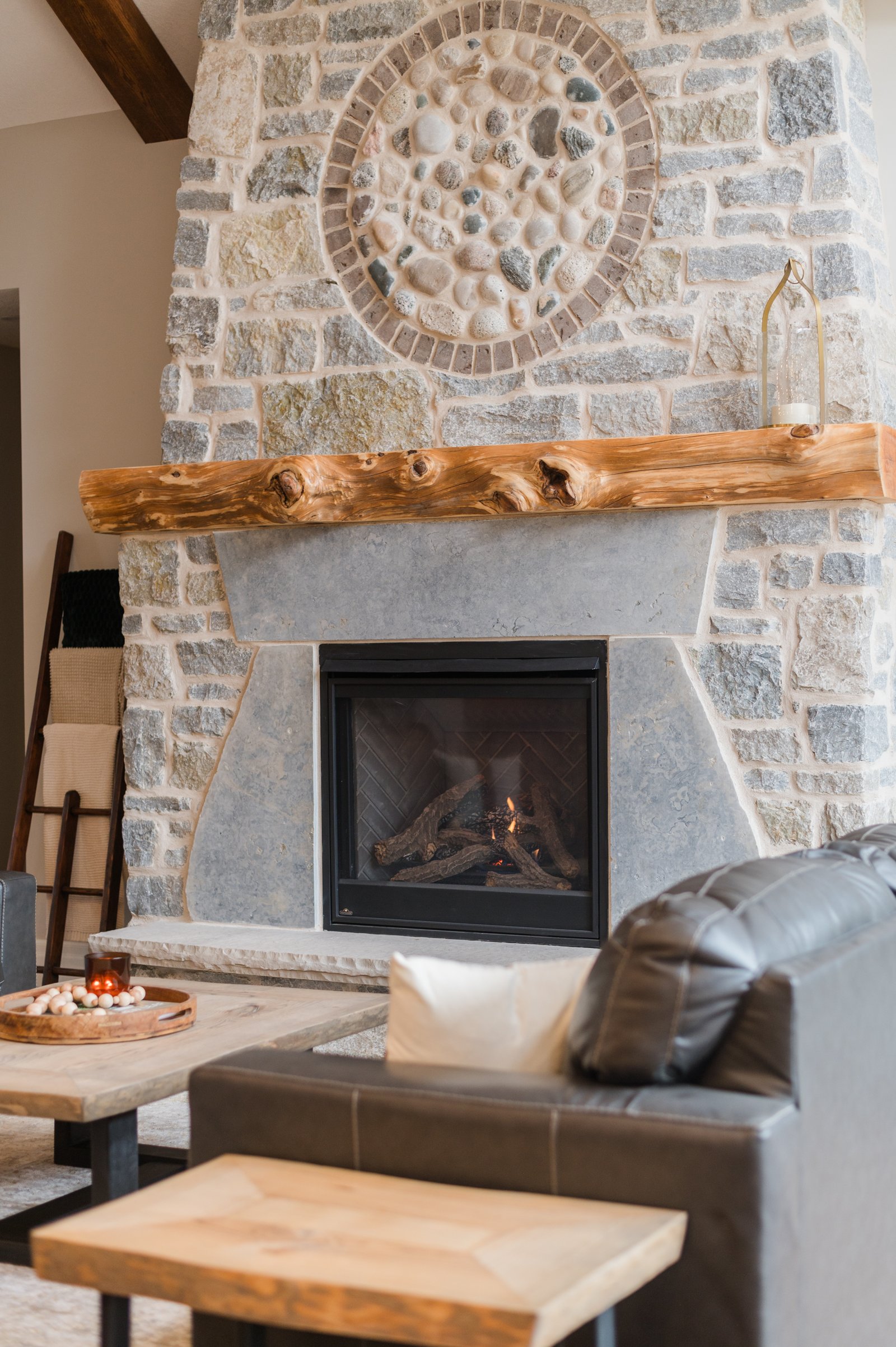 Custom stone fireplace feature wall in a living room.